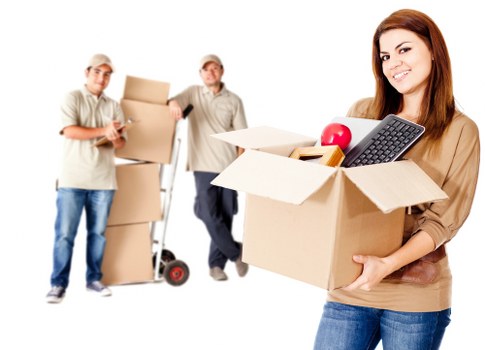 Local movers carrying household items through a London property entrance