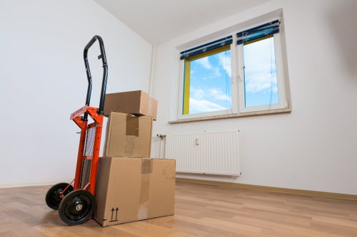 Local movers handling a business move in a busy London street