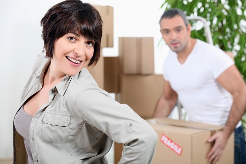 Professional movers packing household items for a London move
