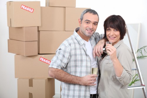 Driver and helper loading furniture into a moving van